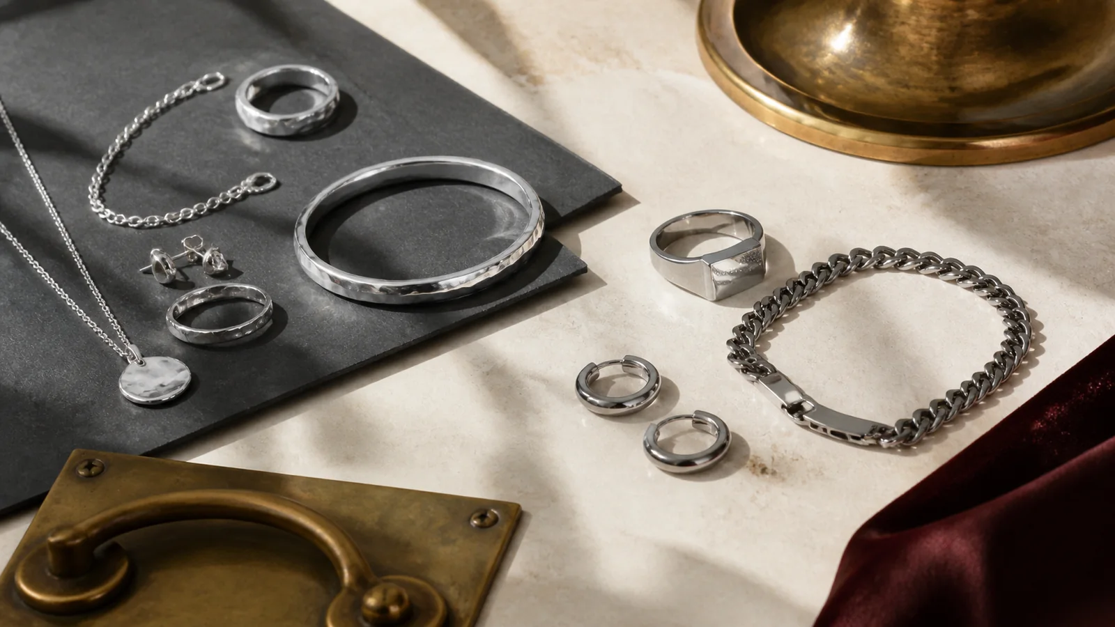 Editorial still life for Sterling Silver vs Stainless Steel Jewellery: Finish, Care and Product Disclosure